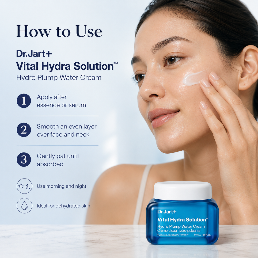 A woman applies white cream to her face while a blue jar of Dr.Jart+ Vital Hydra Solution Hydro Plump Water Cream sits on a marble surface.