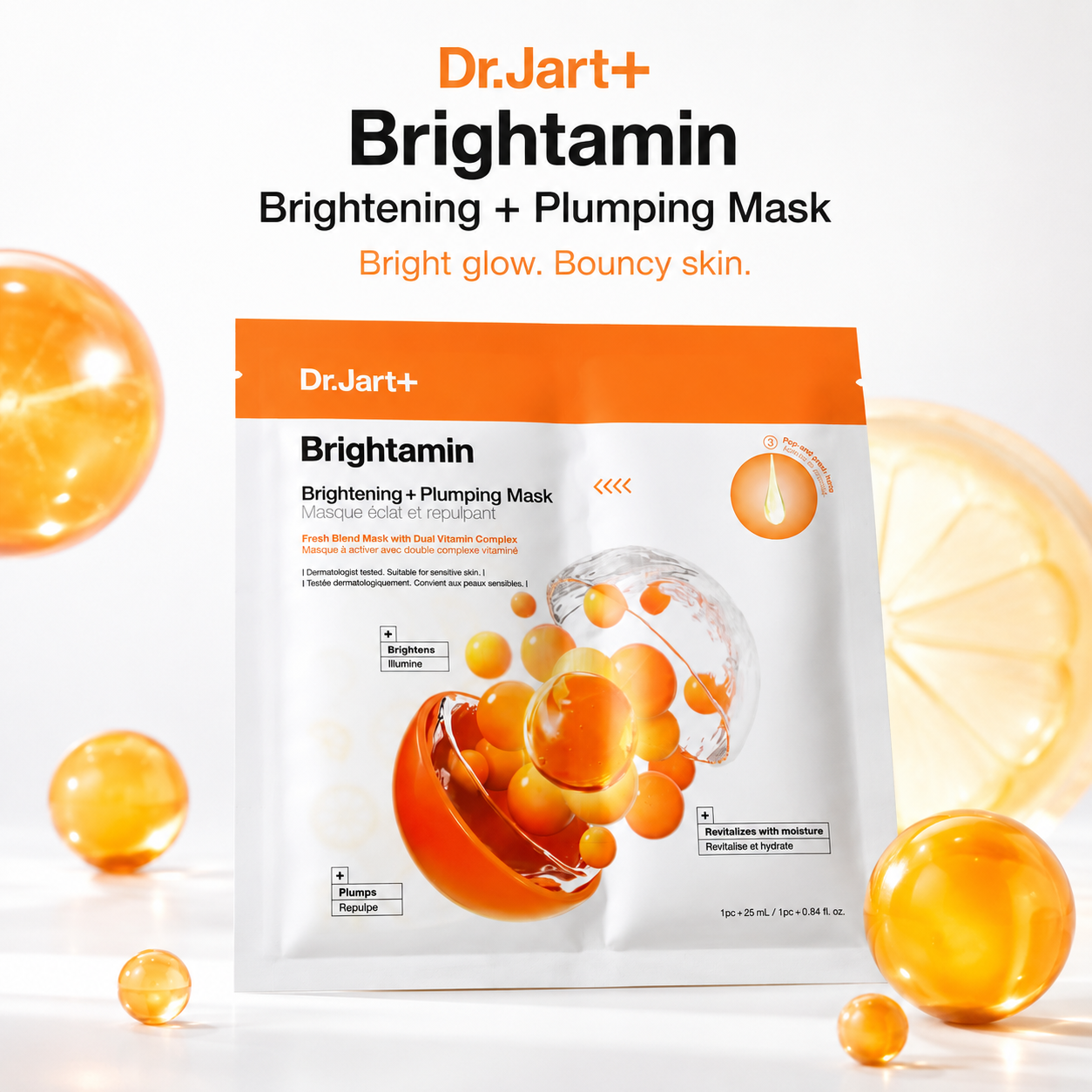 Dr.Jart+ Brightamin Brightening + Plumping Mask in a white stand-up pouch with orange accents, surrounded by translucent orange serum droplets on a clean white background.