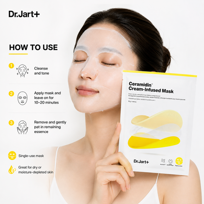 A woman wearing a translucent sheet mask holds a package of Dr.Jart+ Ceramidin Cream-Infused Mask next to a &