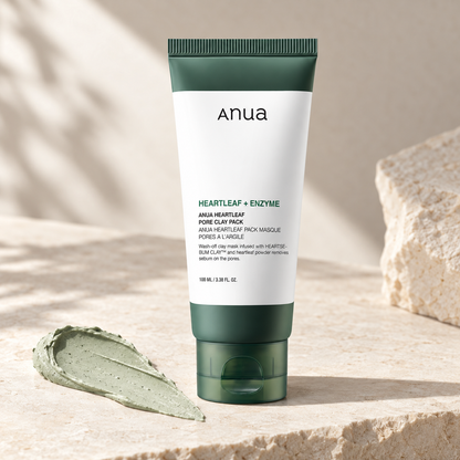 Anua Heartleaf Pore Clay Pack 100ml with green clay texture on ivory stone